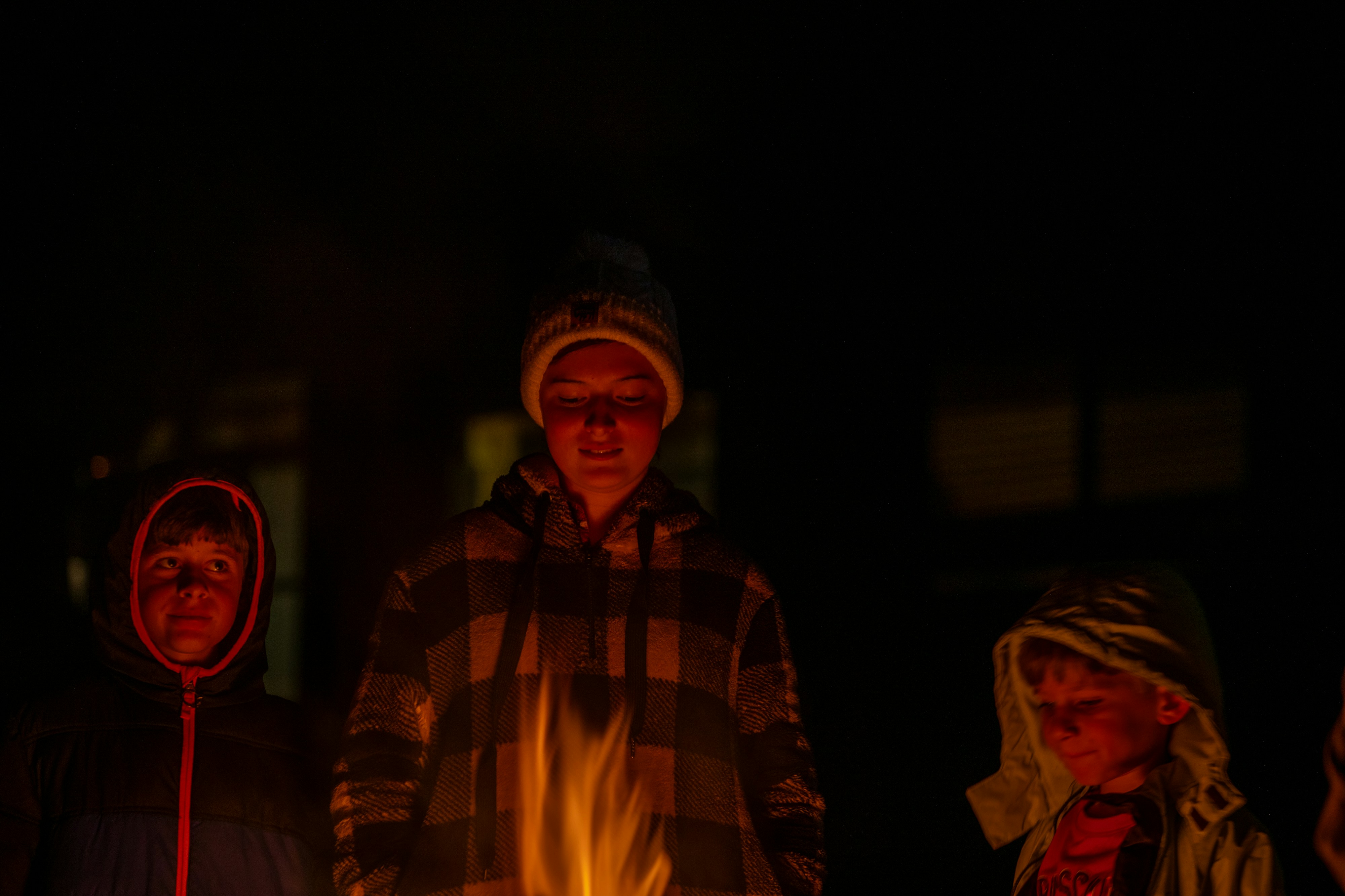 Families receiving winter heating supplies during a cold night