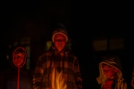 Children laughing and playing around a bonfire at a local festival.