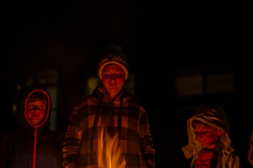 Families receiving winter heating supplies during a cold night