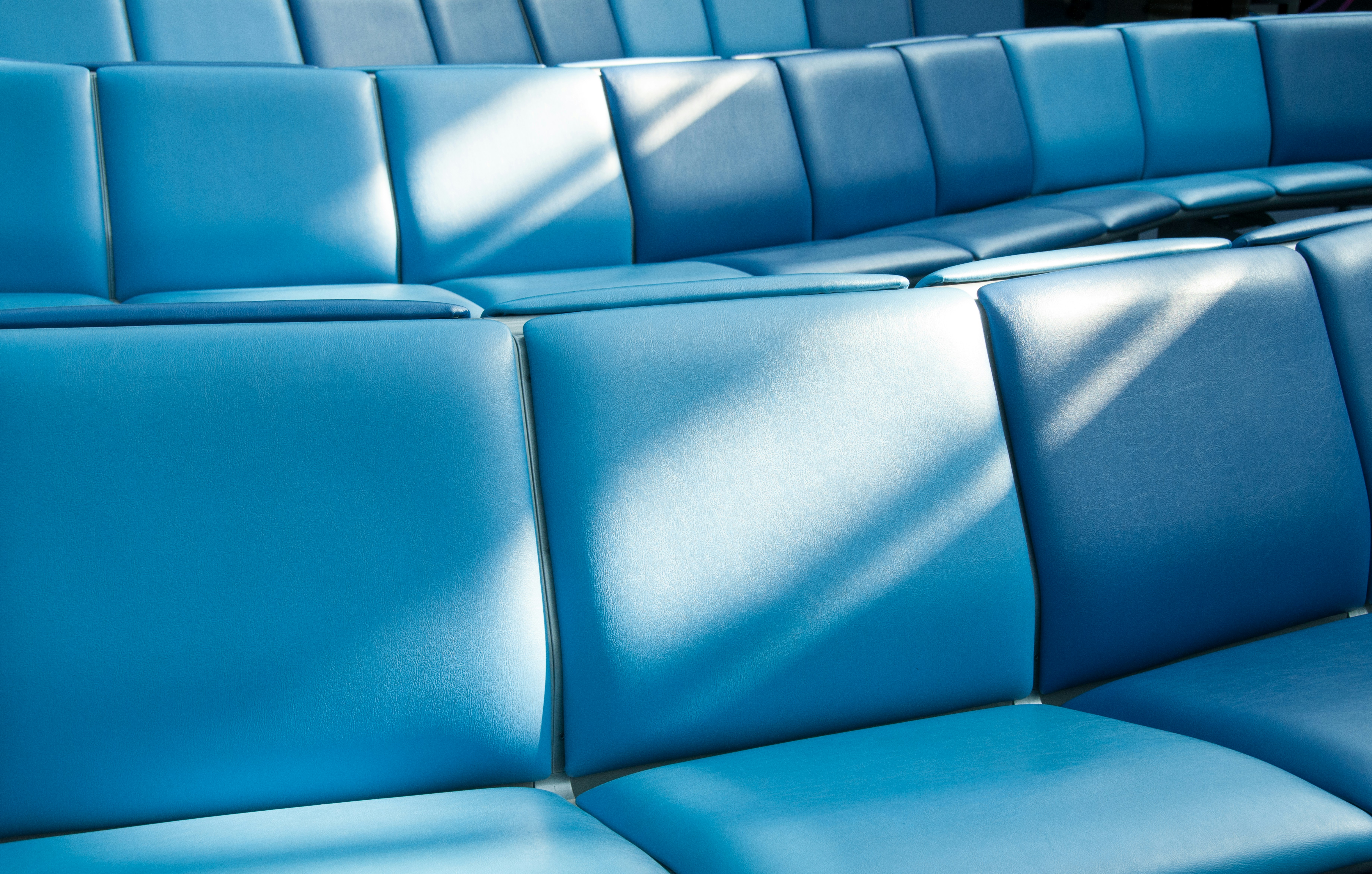 a row of blue seats sitting next to each other