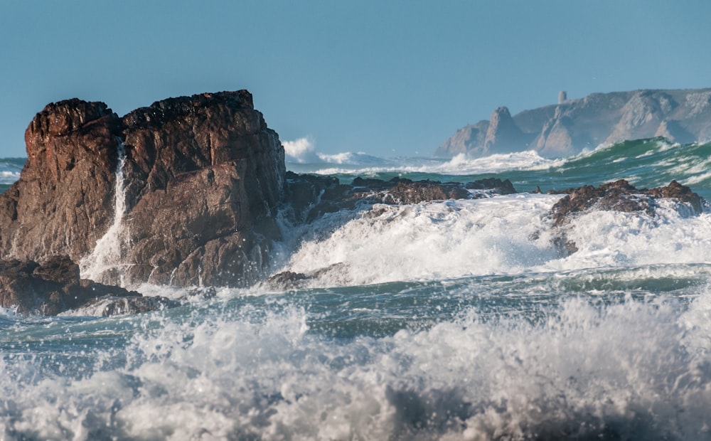 a large rock in the middle of the ocean