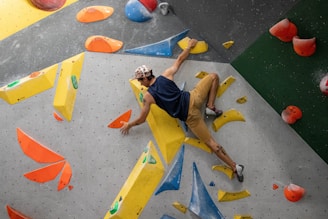 a man is climbing on a climbing wall
