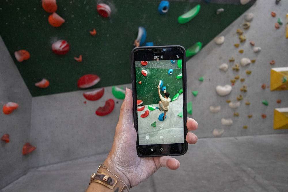 a person taking a picture of a climbing wall