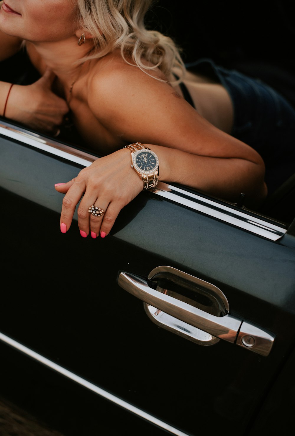 a beautiful blond woman leaning out of a car window