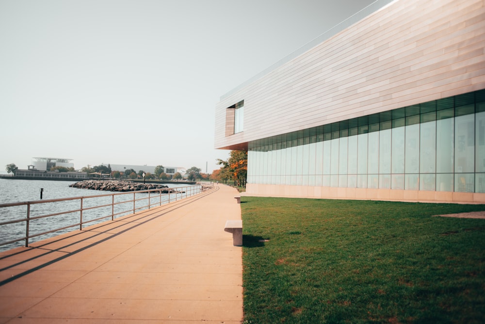 a bench sitting on the side of a walkway next to a body of water