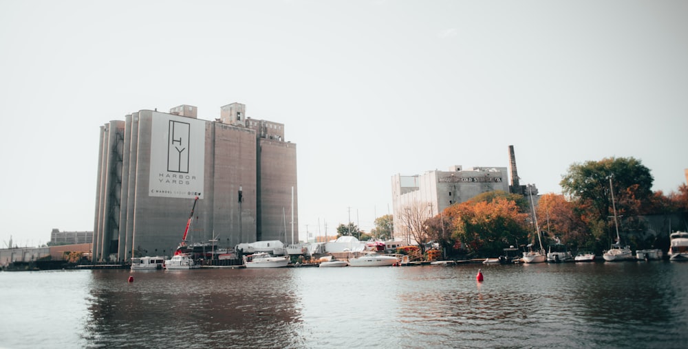 a body of water with boats in front of a building