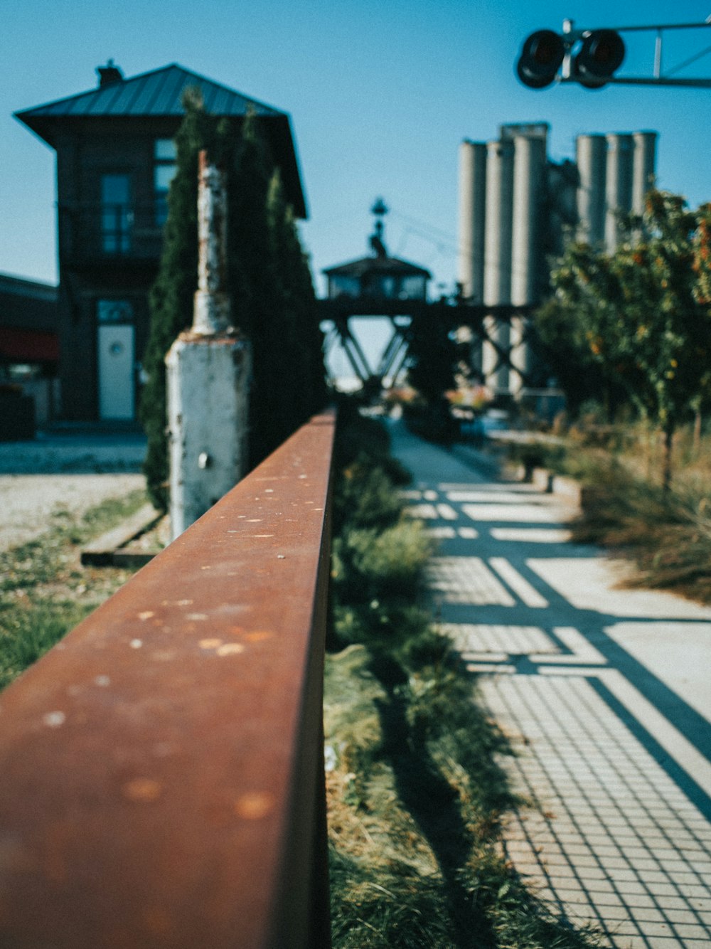 a long red bench sitting on the side of a road