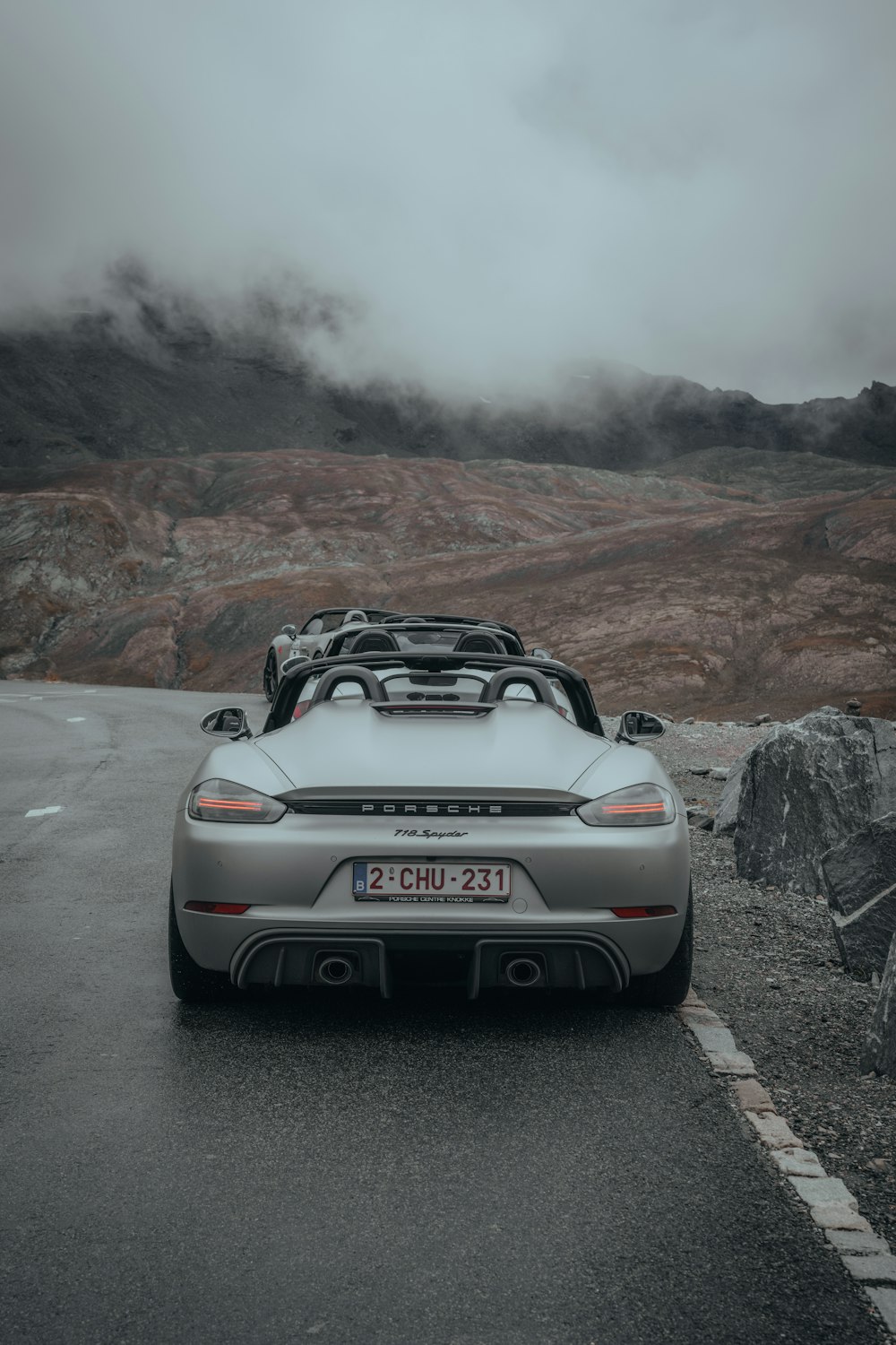 a silver sports car parked on the side of the road