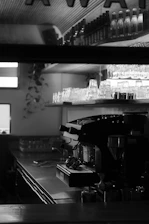 A sleek black and white photo of the expresso team collaborating in a modern office space with gold accent decor.