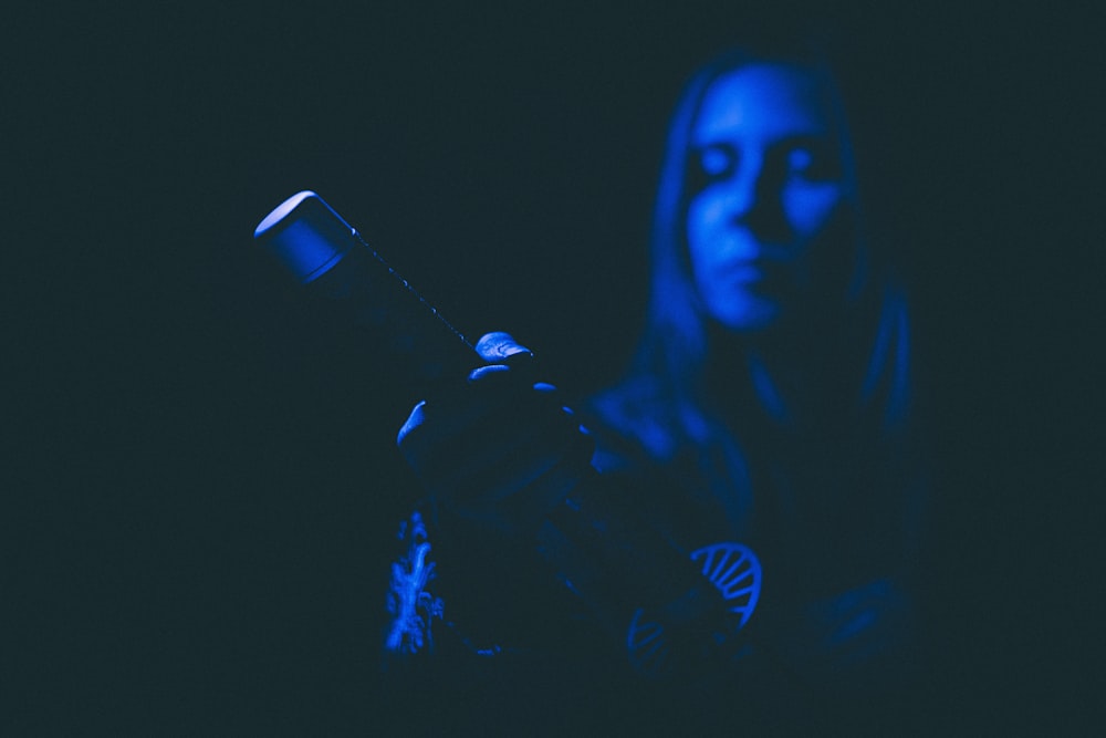a woman holding a flashlight in her hand