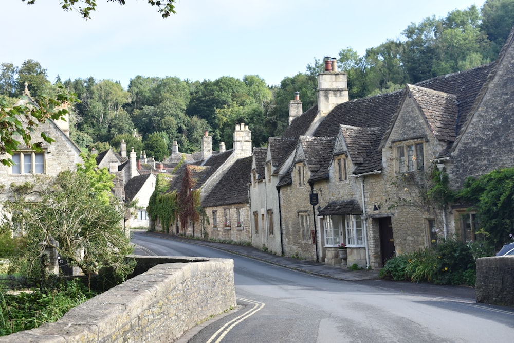 a street lined with stone houses and trees
