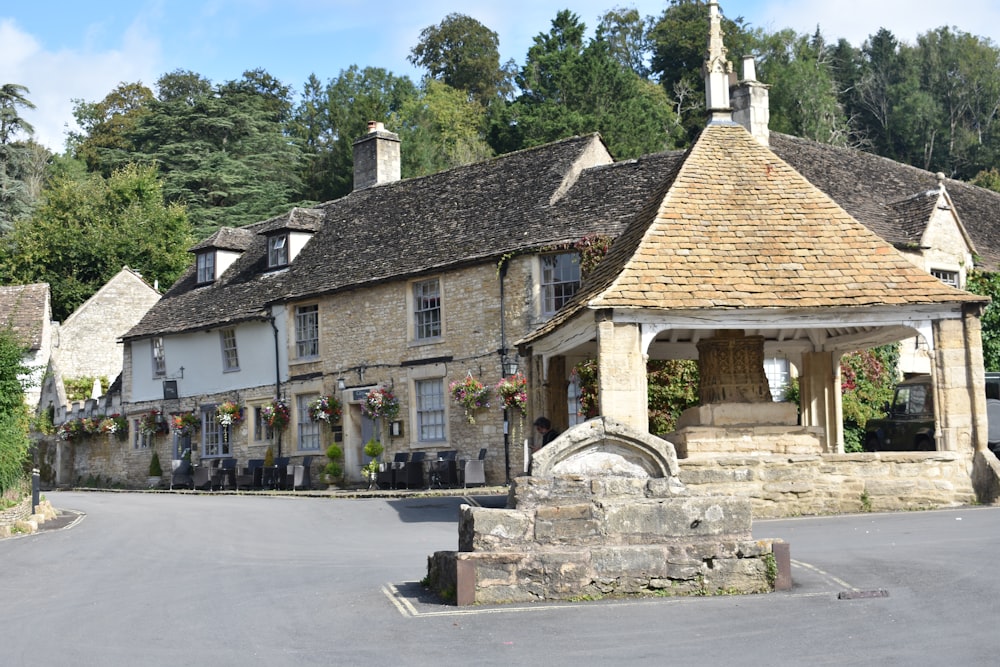 a stone building with a clock tower in front of it