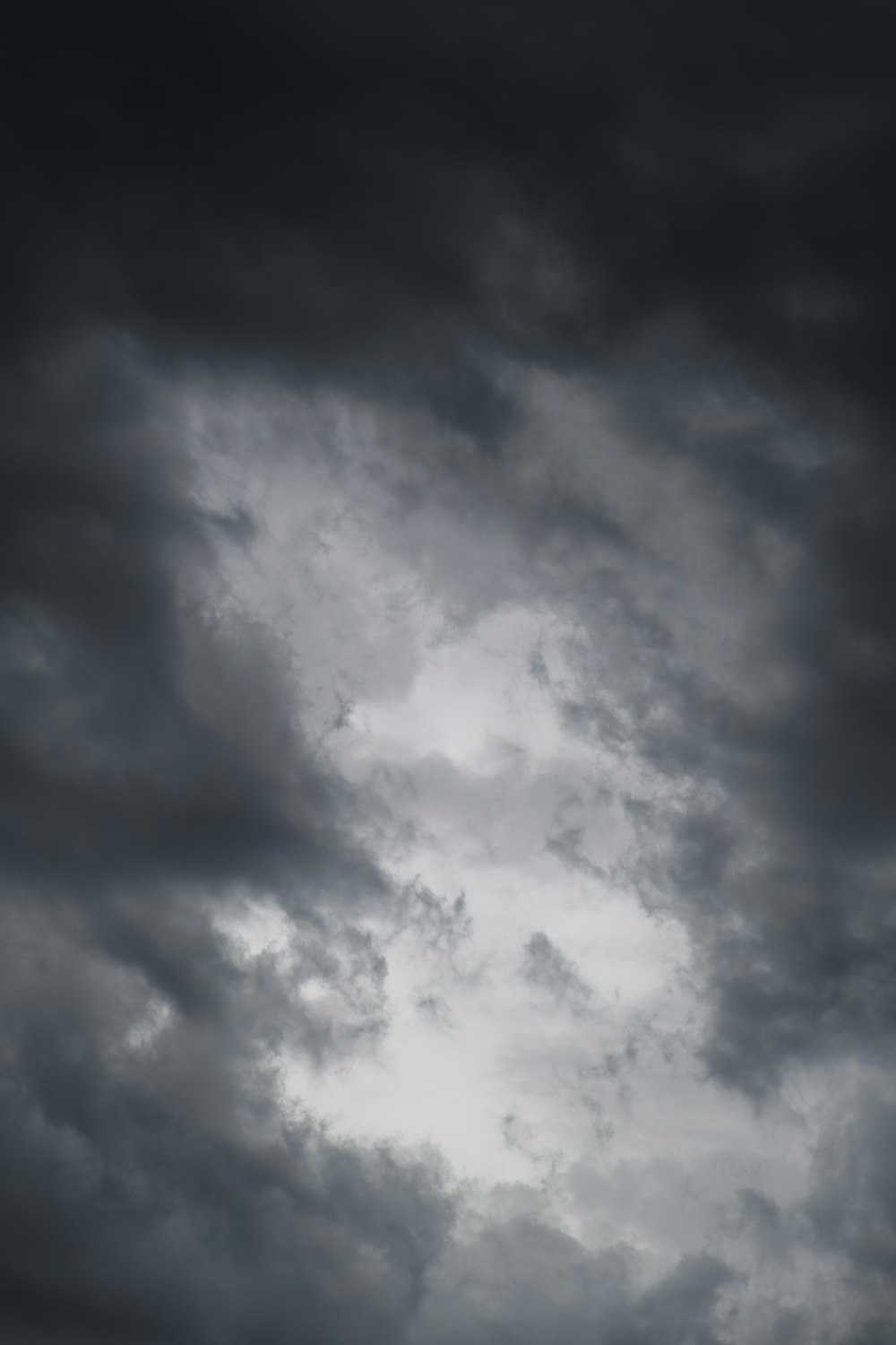 a plane flying through a dark cloudy sky