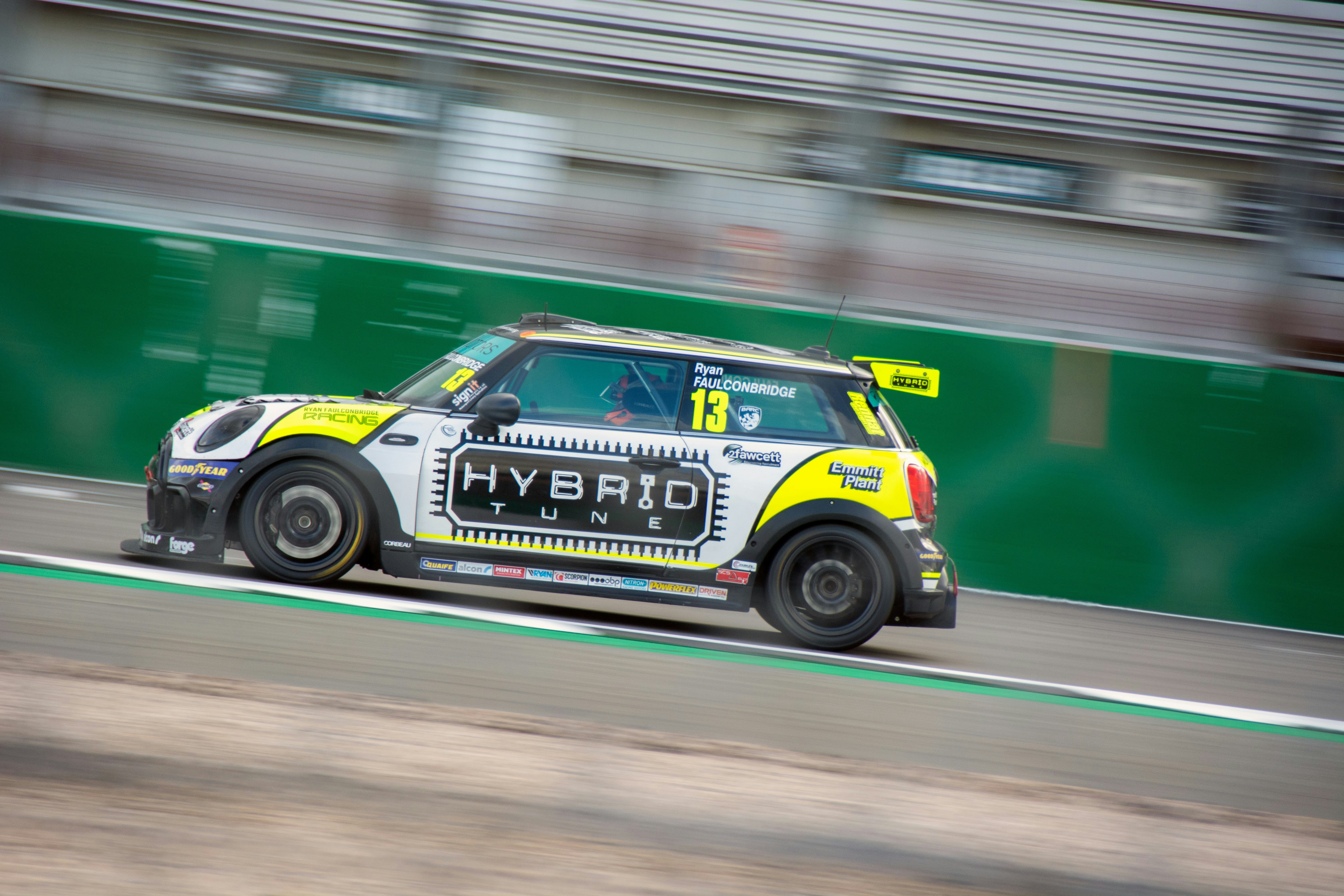 A small car driving down a race track photo – Free Uk Image on Unsplash