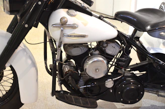 Close-up of a vintage Harley engine gleaming under natural light.