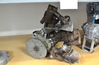 A collection of various engine spare parts displayed on shelves.