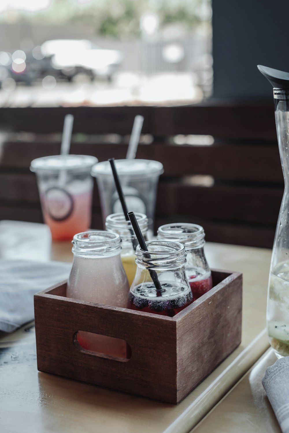 a wooden tray topped with drinks and a blender