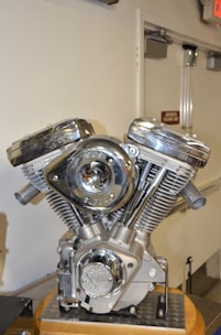 Shiny motorcycle engine parts displayed on a mechanic's workbench.