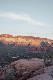 A serene red rock formation under a vibrant sunset sky near Sedona, evoking calm and groundedness.
