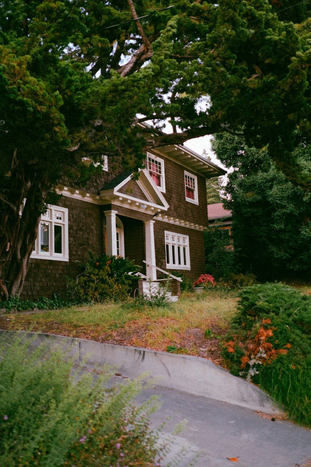 a brown house with white trim and windows