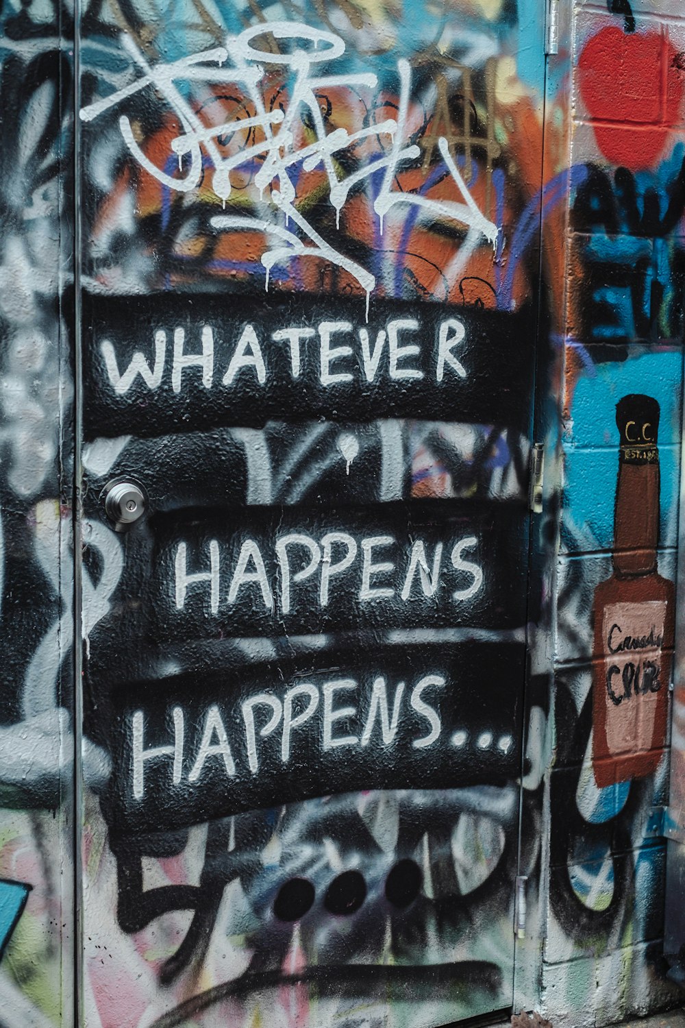 a wall covered in graffiti with a message written on it