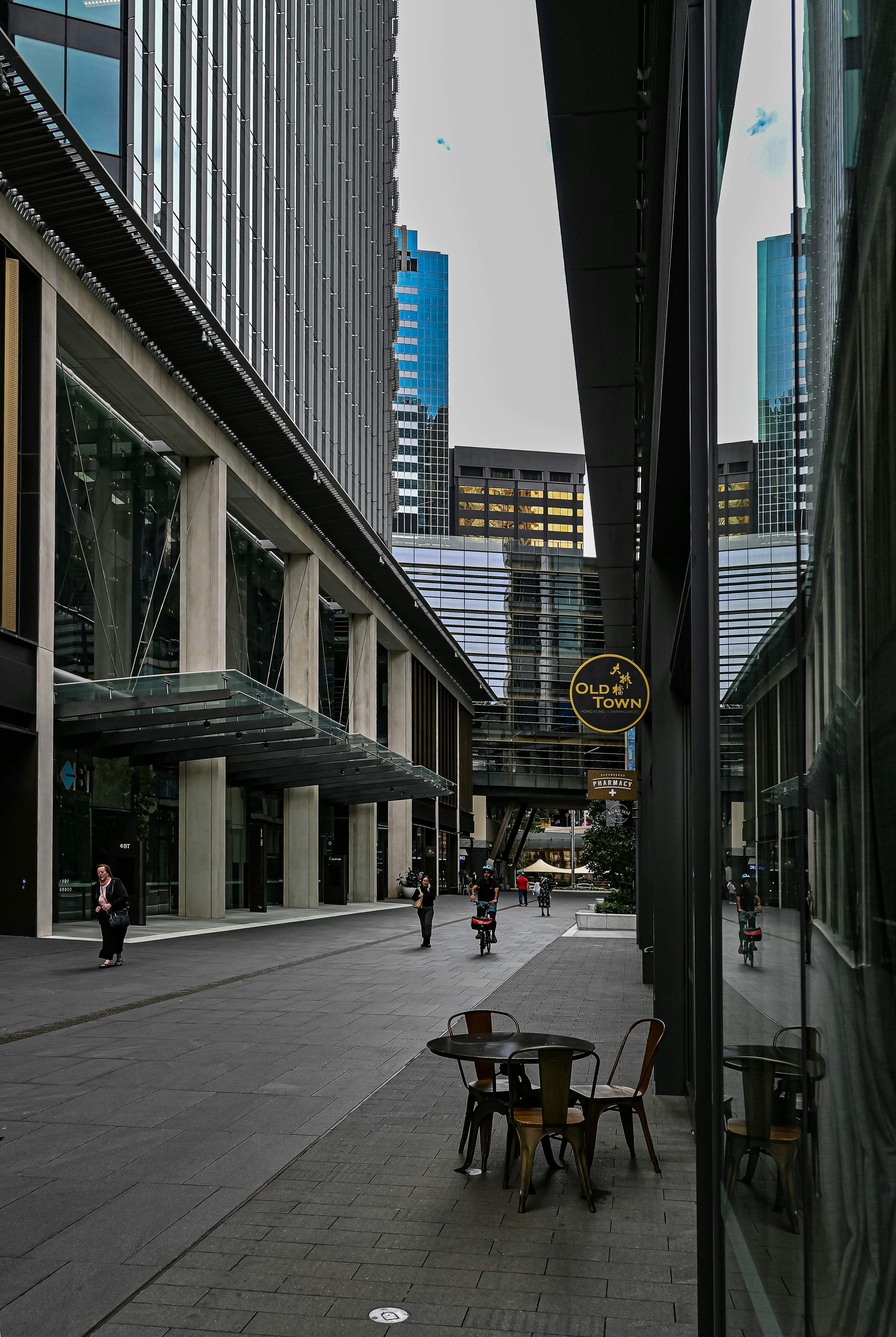 a city street with tables and chairs in the middle of it