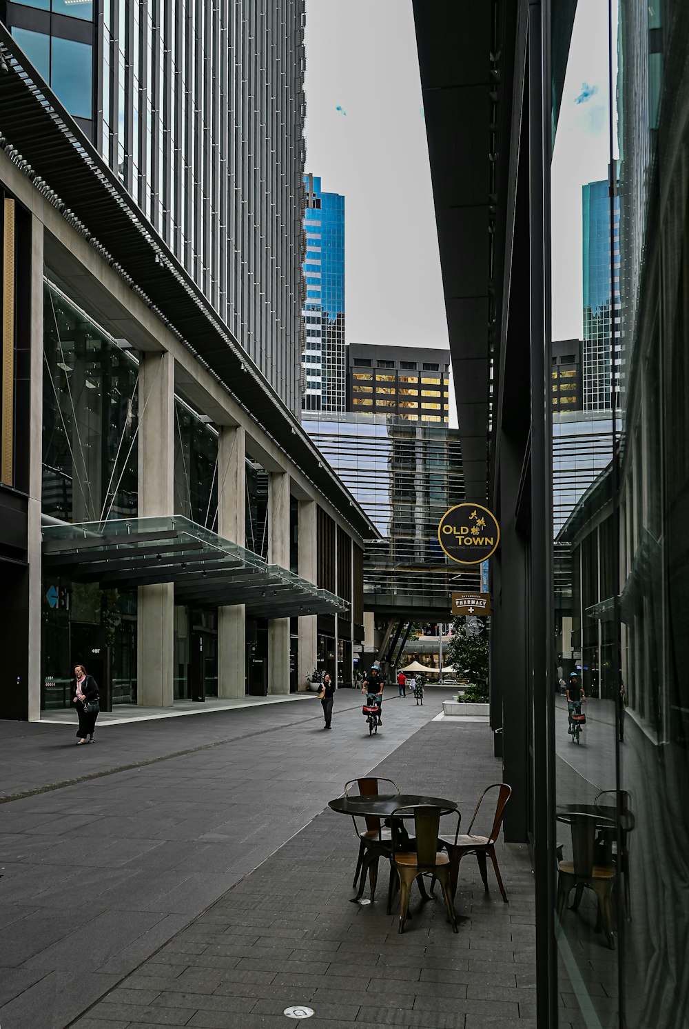 a city street with tables and chairs in the middle of it