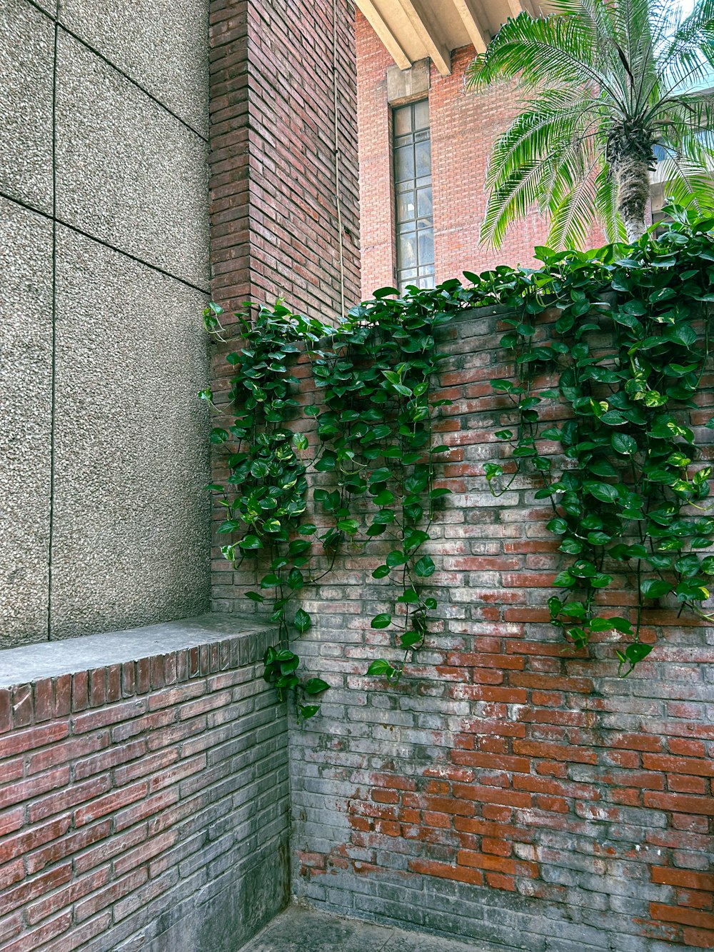 a red fire hydrant sitting next to a brick wall