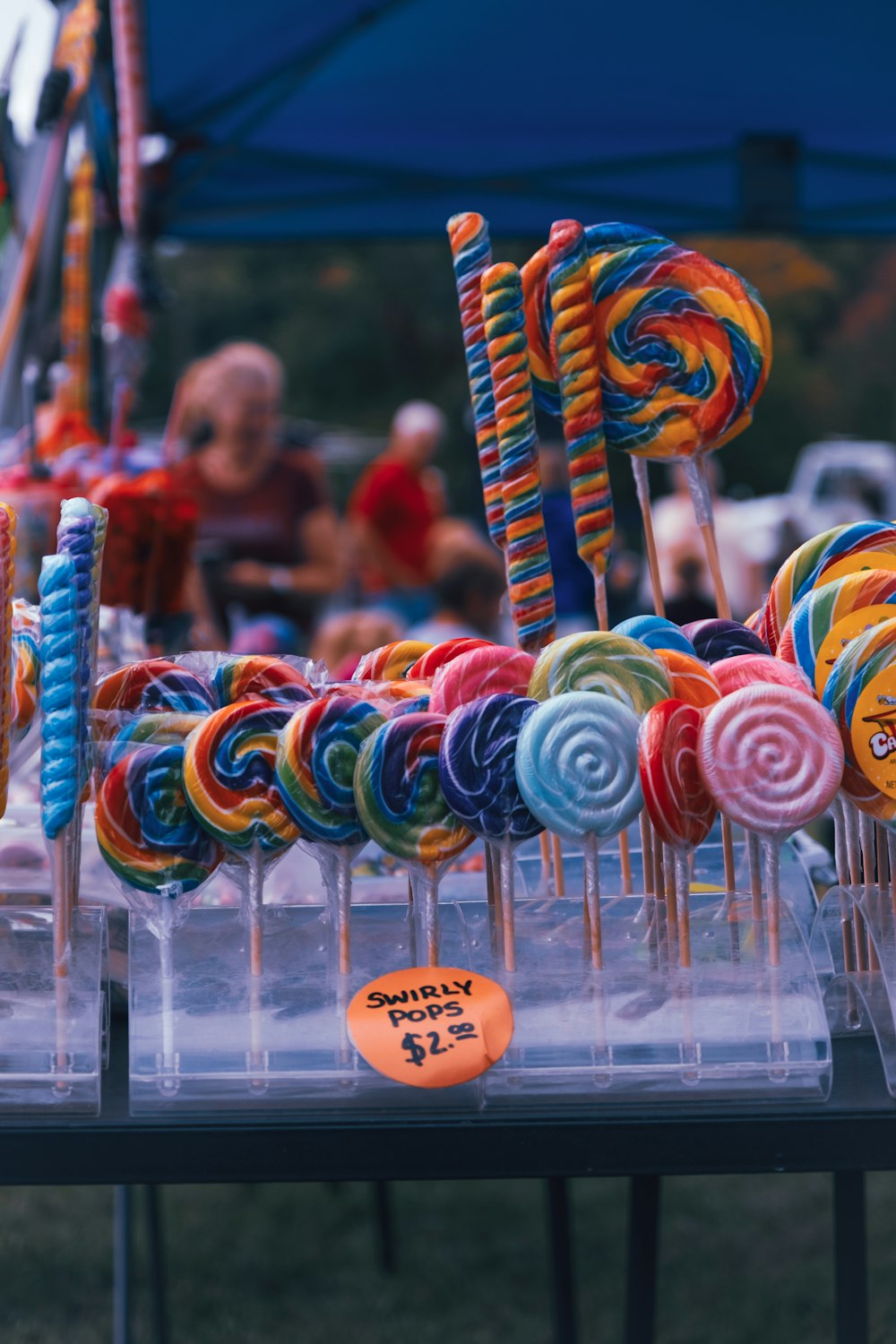 a table topped with lots of colorful lollipops