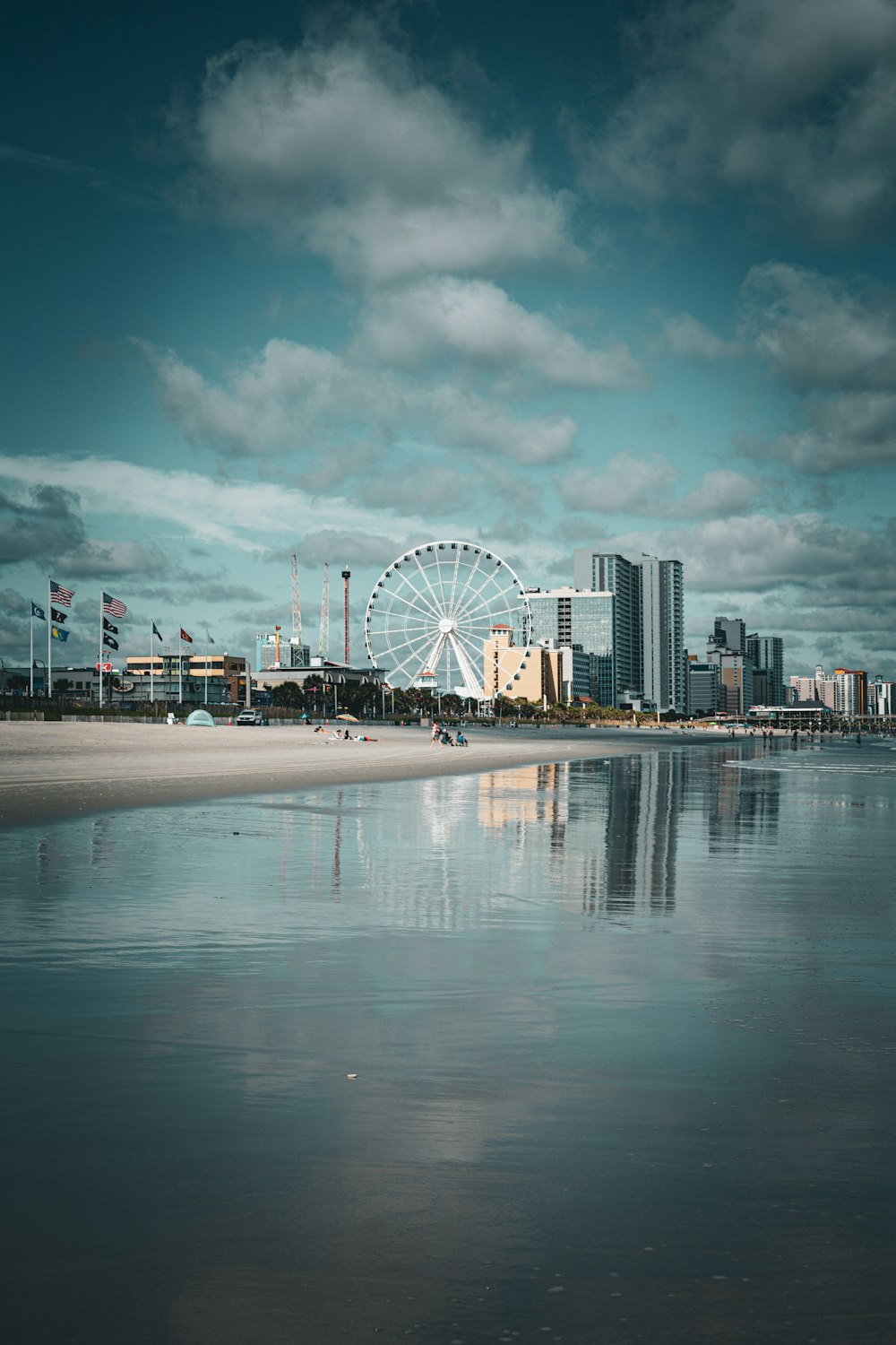 a large ferris wheel sitting next to a body of water