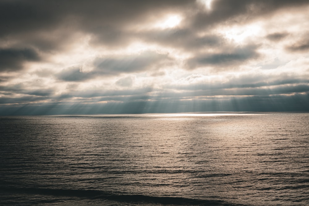 a large body of water under a cloudy sky