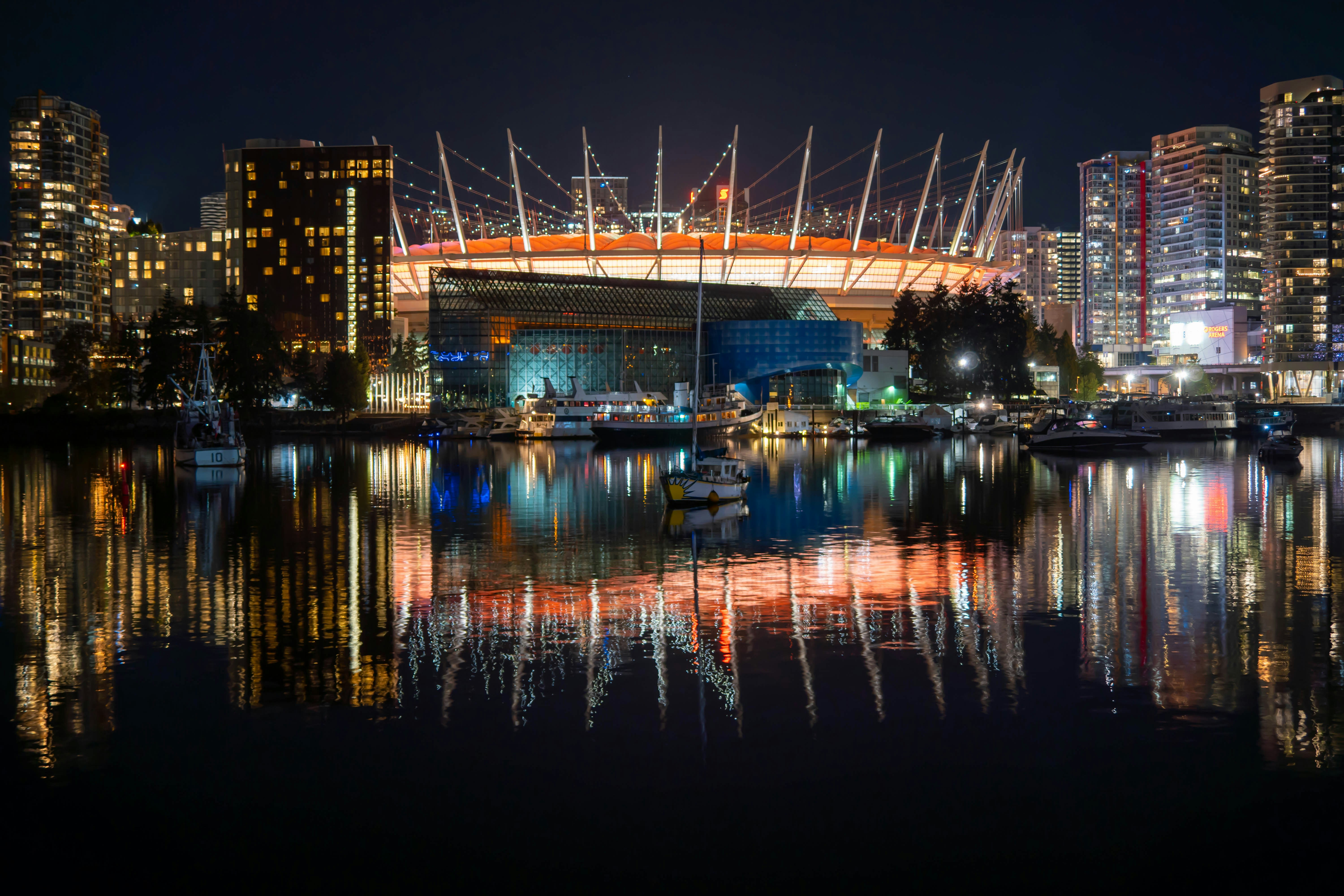 a city skyline at night with a bridge over a body of water