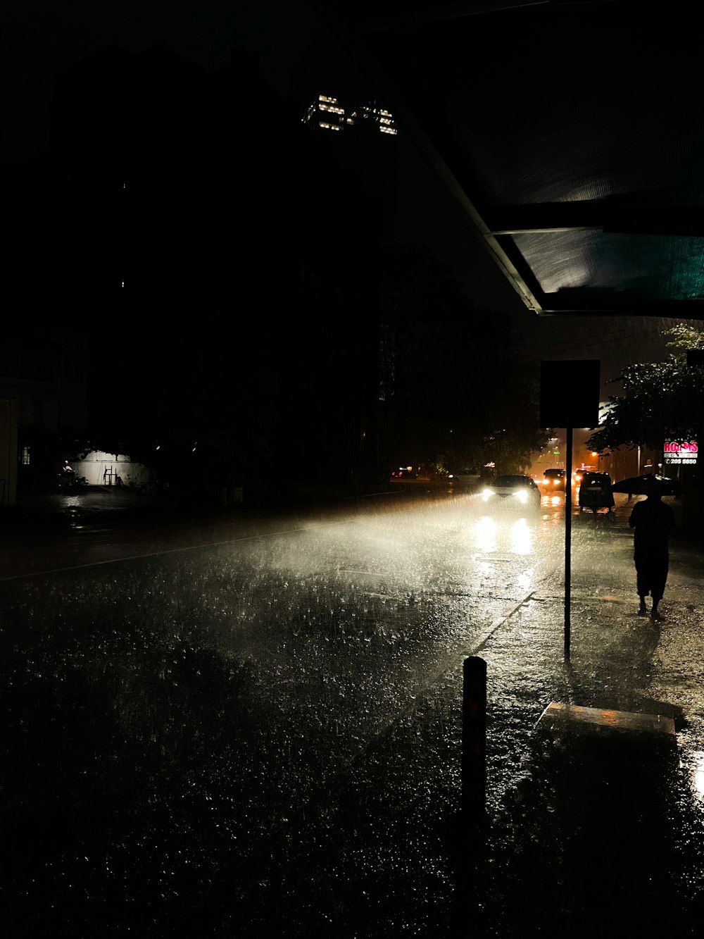 a person walking down a street at night