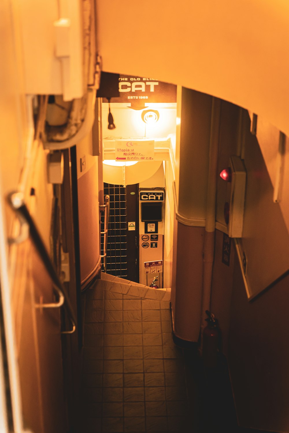 a narrow hallway with a light on and a phone on the wall