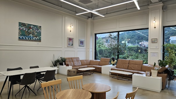 a living room filled with furniture and a large window
