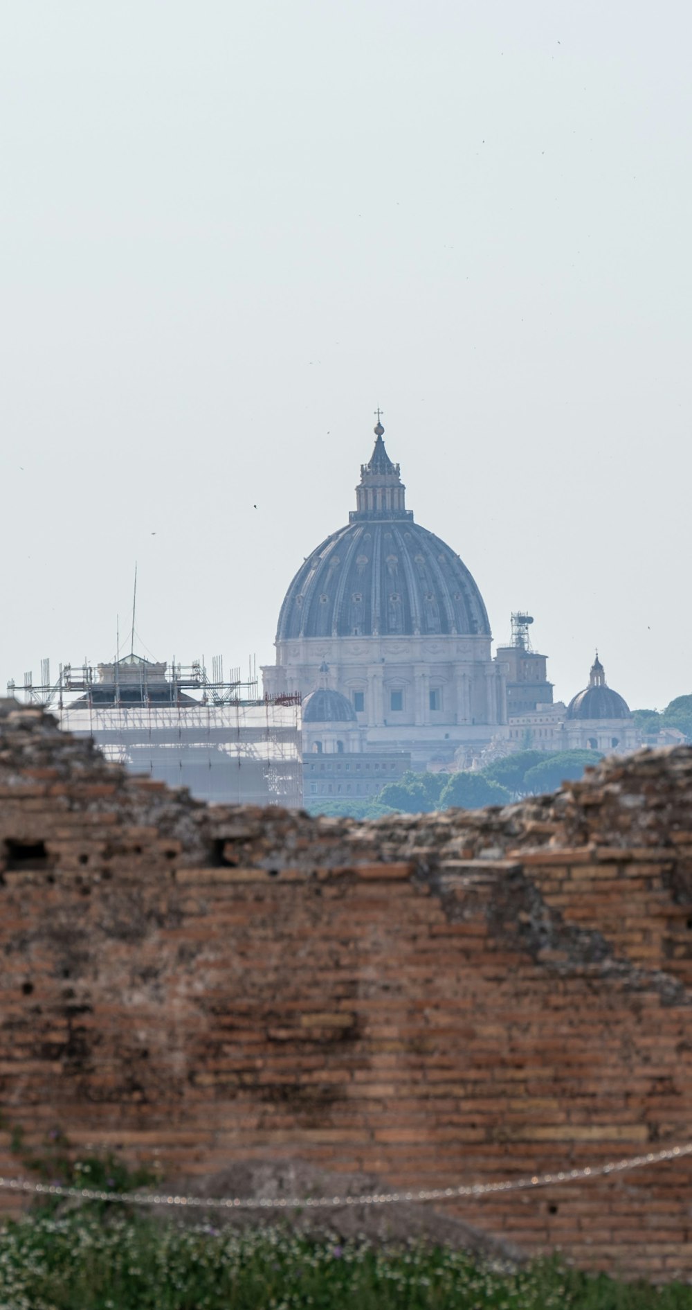 a view of a building with a dome in the background