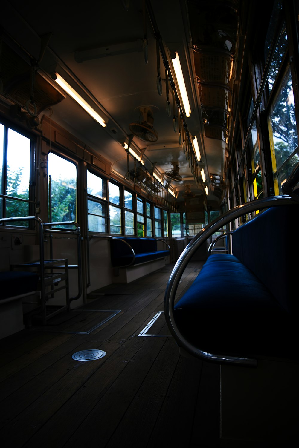 a train car with lots of windows and blue seats