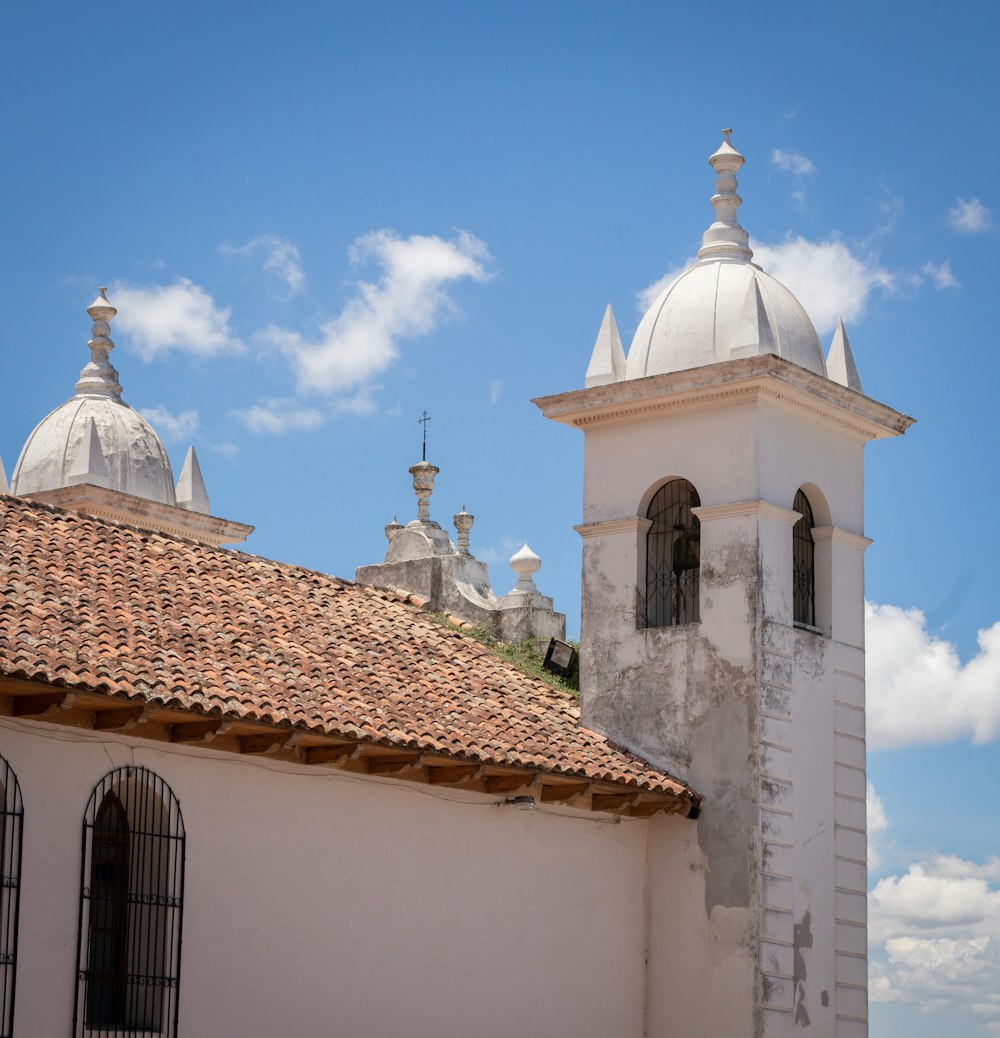 a white building with a red tiled roof