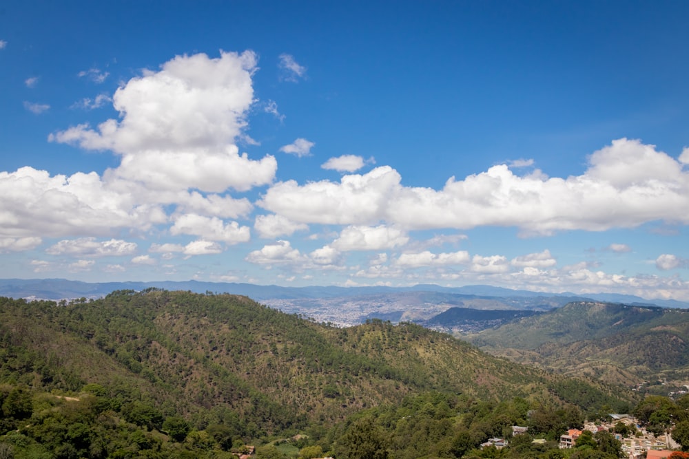 a scenic view of a mountain range with clouds in the sky