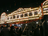 Evening shot of the marquee with twinkling lights and a festive atmosphere.