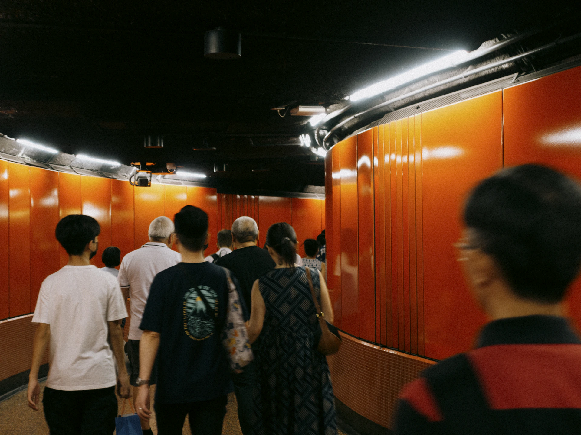 a group of people walking down a hallway