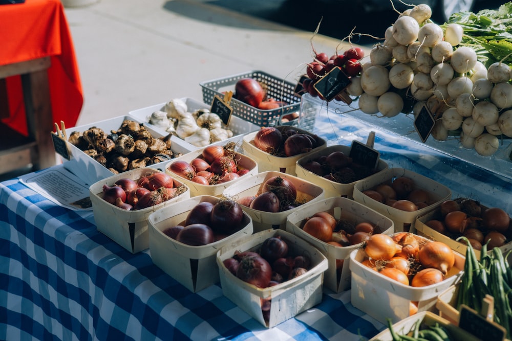 a table topped with baskets of fruit and vegetables