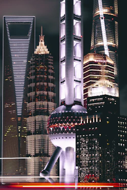 A striking nighttime cityscape of Abu Dhabi illuminated with neon lights reflecting modern architectural designs.