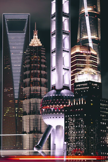 A striking nighttime cityscape of Abu Dhabi illuminated with neon lights reflecting modern architectural designs.