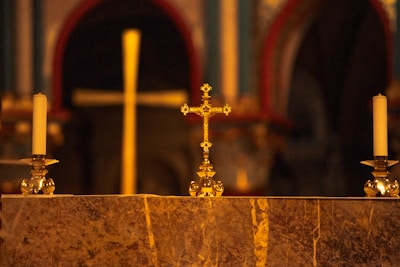 A beautifully arranged altar with candles and crosses.