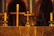 Candles burning softly on a rustic wooden altar with a cross in the background.