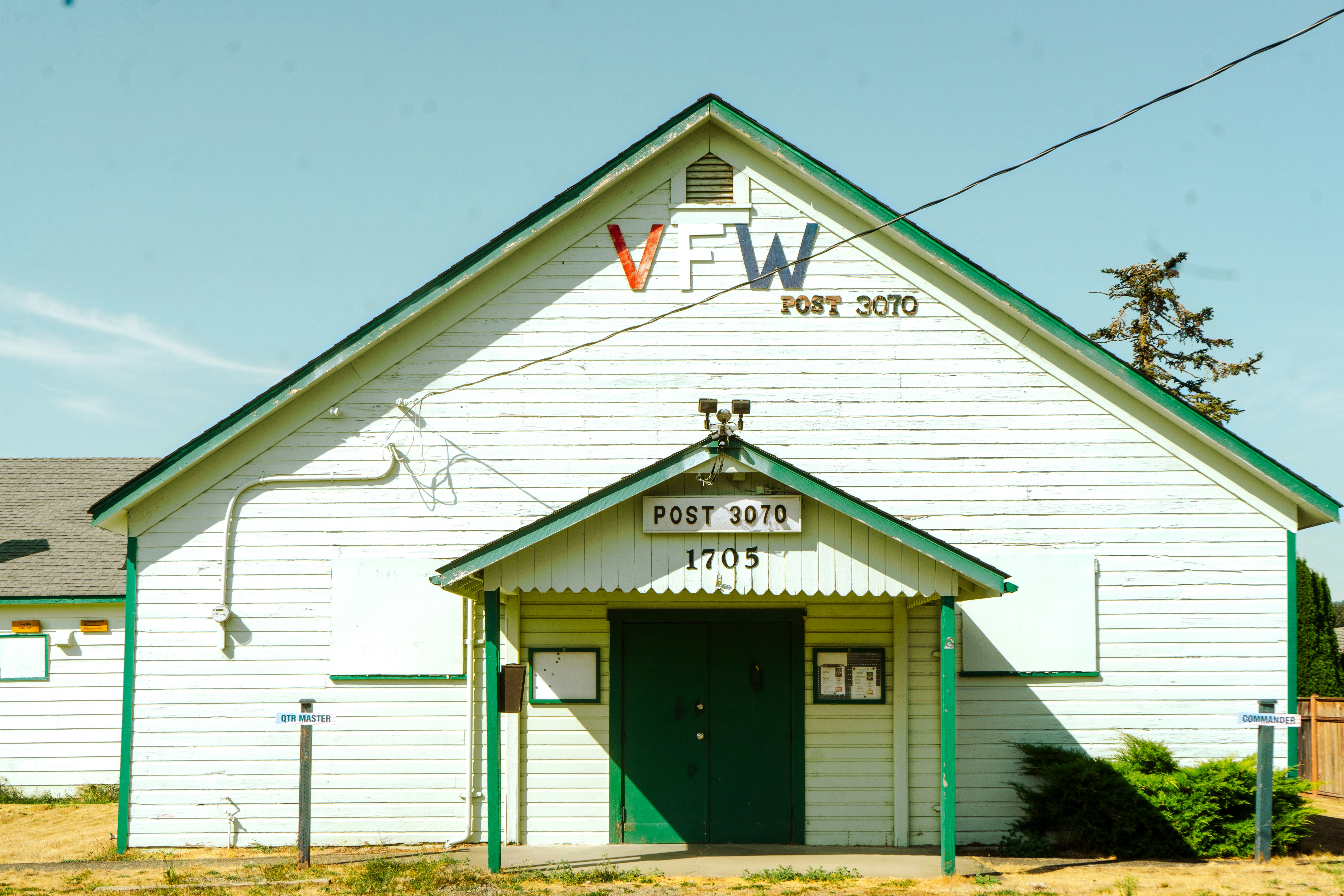 a small white church with a green door