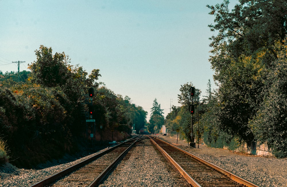 a train track with a red light at the end of it