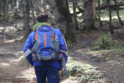 A customer wearing the flap-jacket® while hiking through a forest trail.
