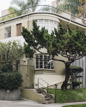 An exterior view of a kost building with greenery and a welcoming entrance.